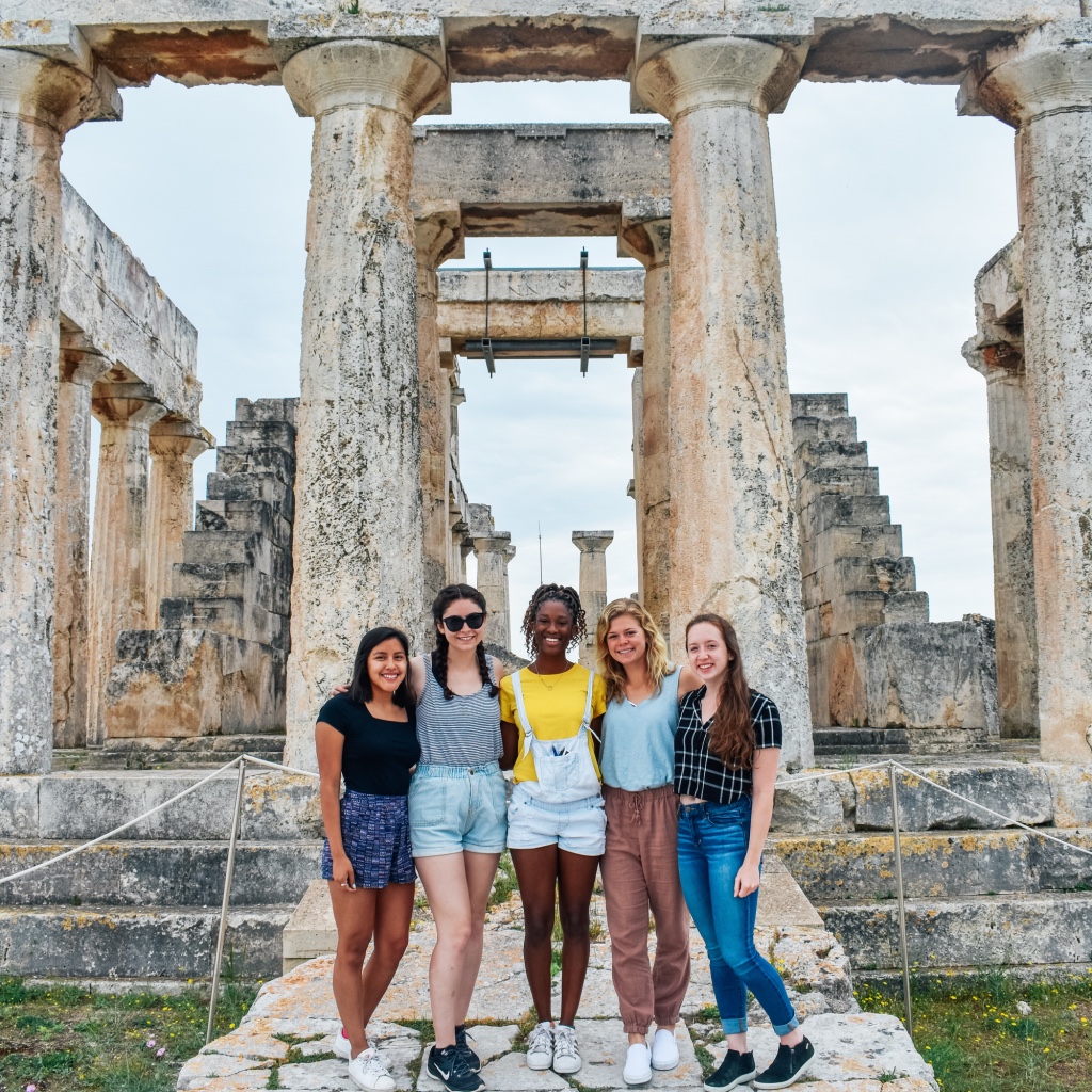 Photo of 5 Tech students standing in front of columns in Greece.