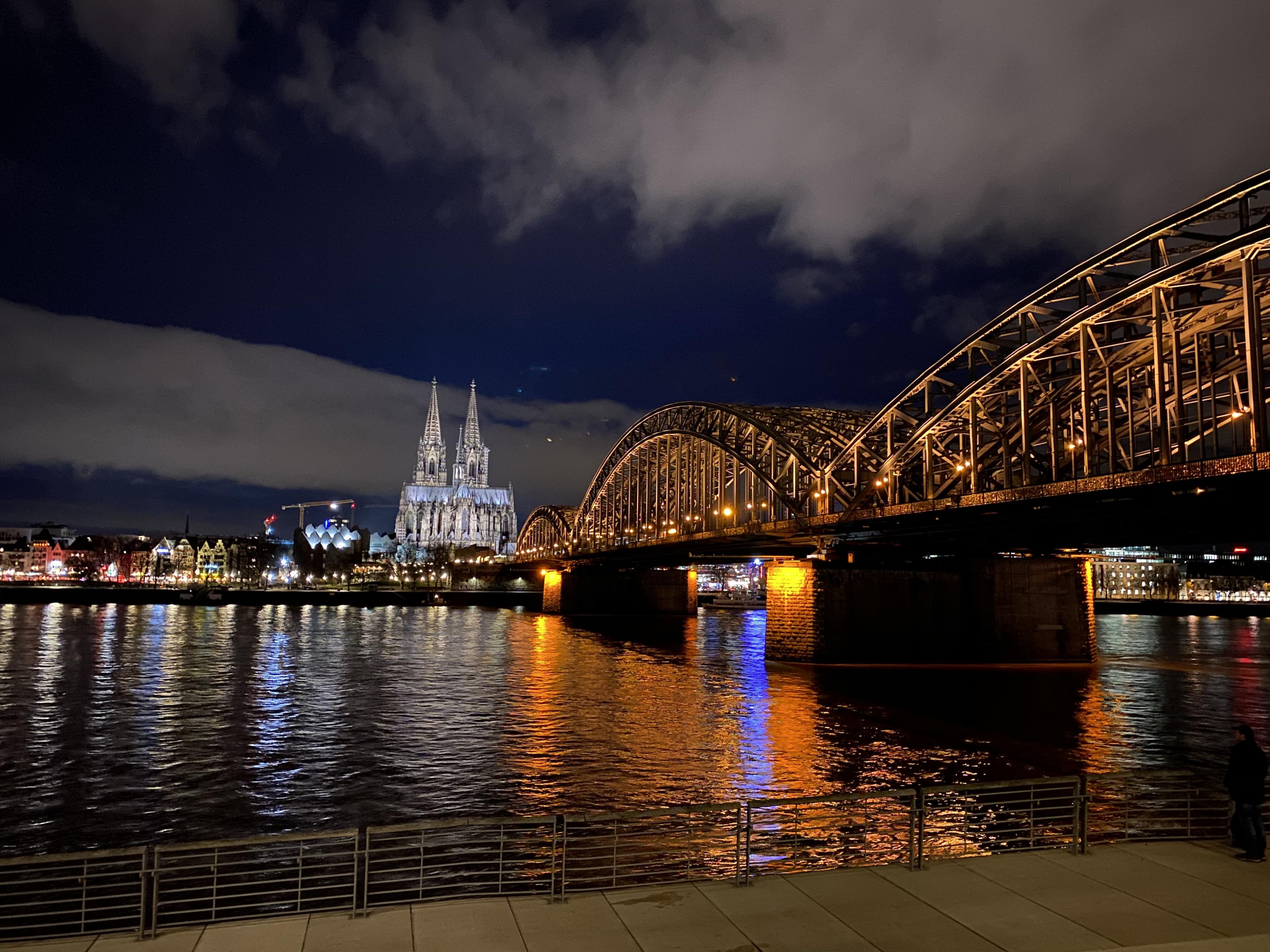 Night photo of a bridge with an elaborate cathedral in the background