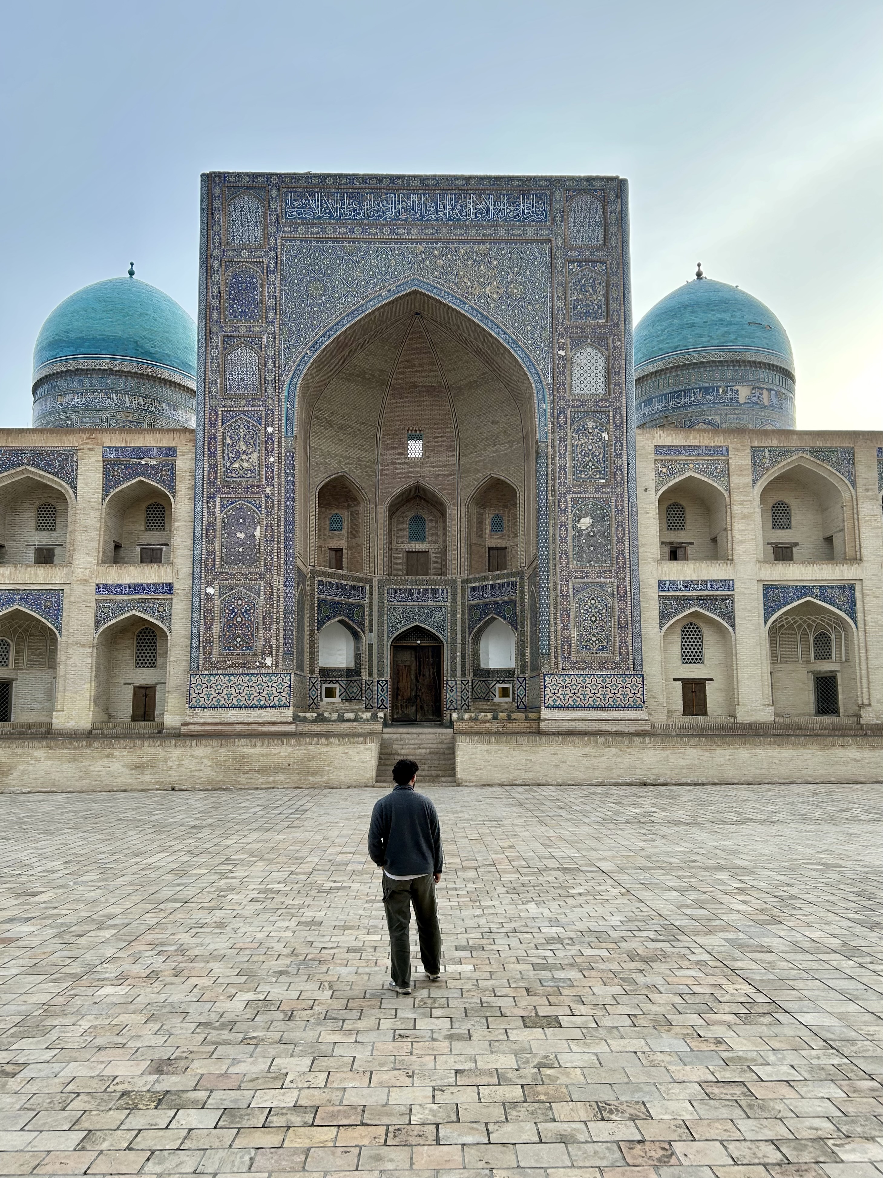 Student in front of the Mir-i-Arab Madrasa in Uzbekistan